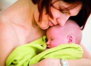 Mother holding sleeping baby girl